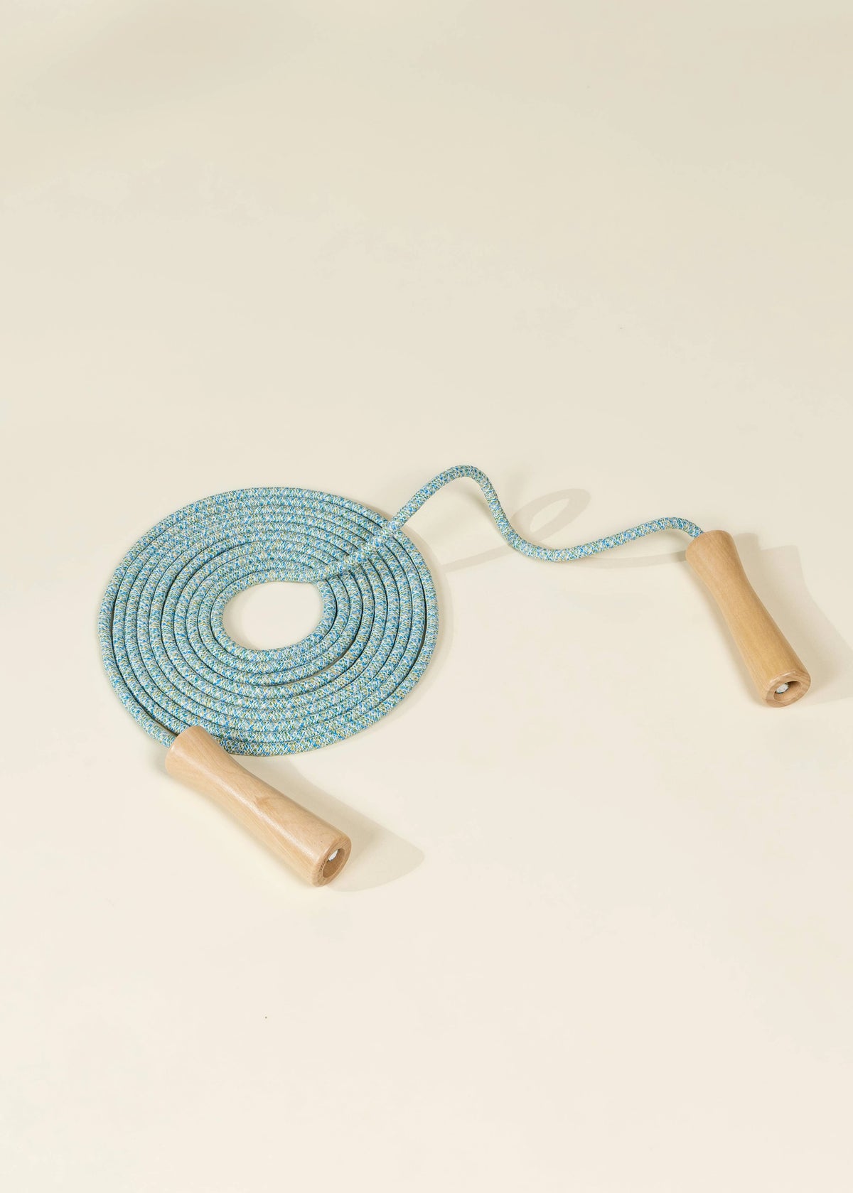 Coco Village blue rope with wooden jump handles, rolled up turquoise rope with two pale wooden handles