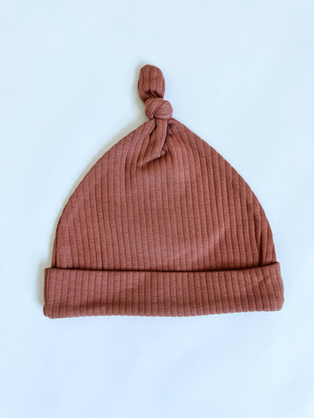 Boho + Babe dusty pink organic cotton baby hat with knotted top, front view