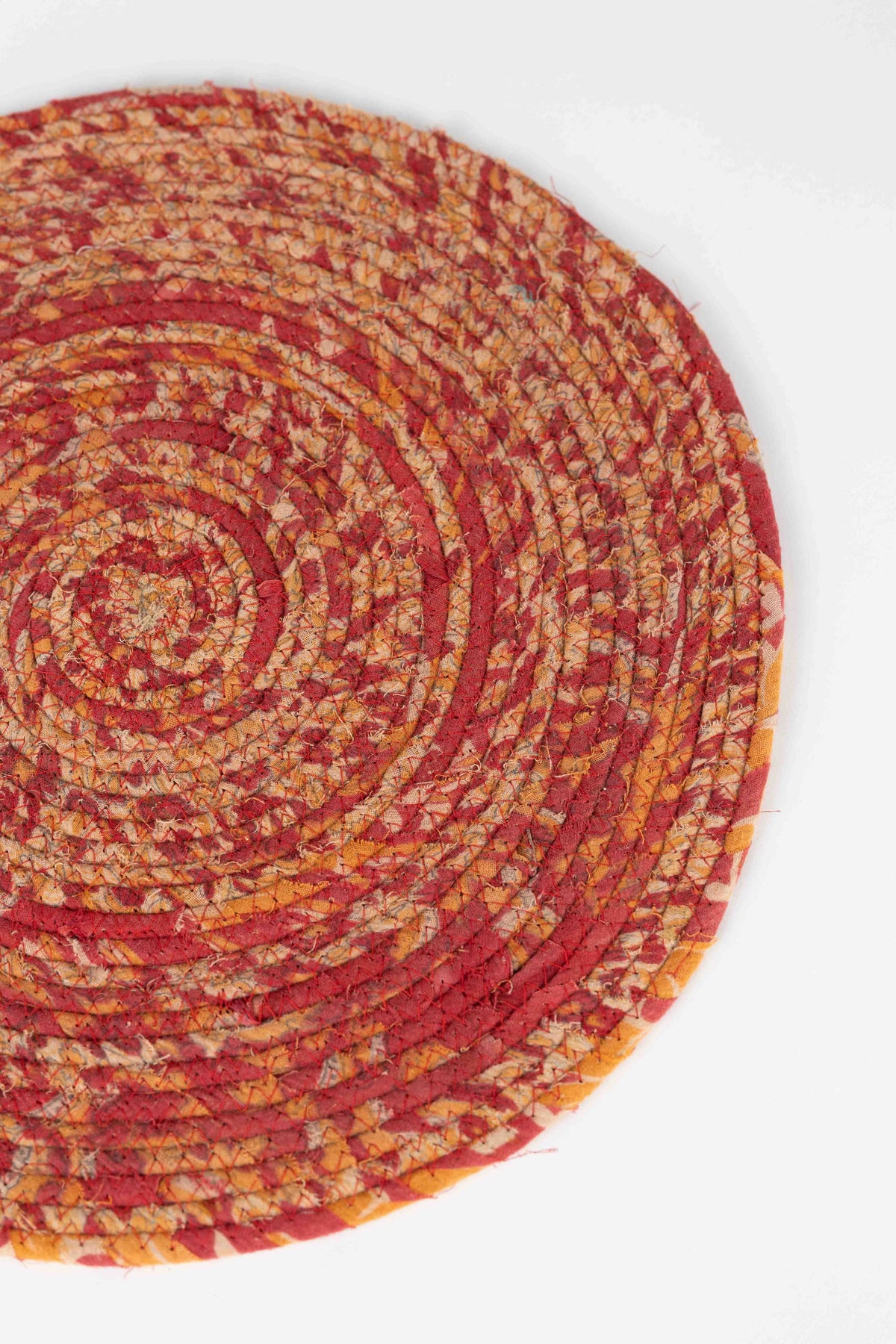 Ten Thousand Villages Recycled Sari Round Placemat: placemat photographed with other objects