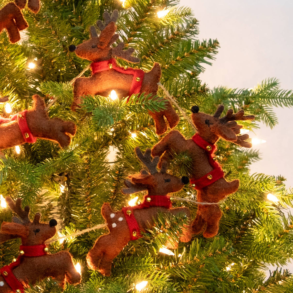 The Winding Road - Garland - Christmas - Santa Sleigh and 8 Reindeer - Brown — reindeer felt garland on decorated Christmas tree