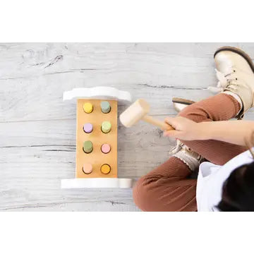 Pearhead FSC-certified wooden toddler hammer bench toy, toddler tapping colorful pegs through wooden play bench