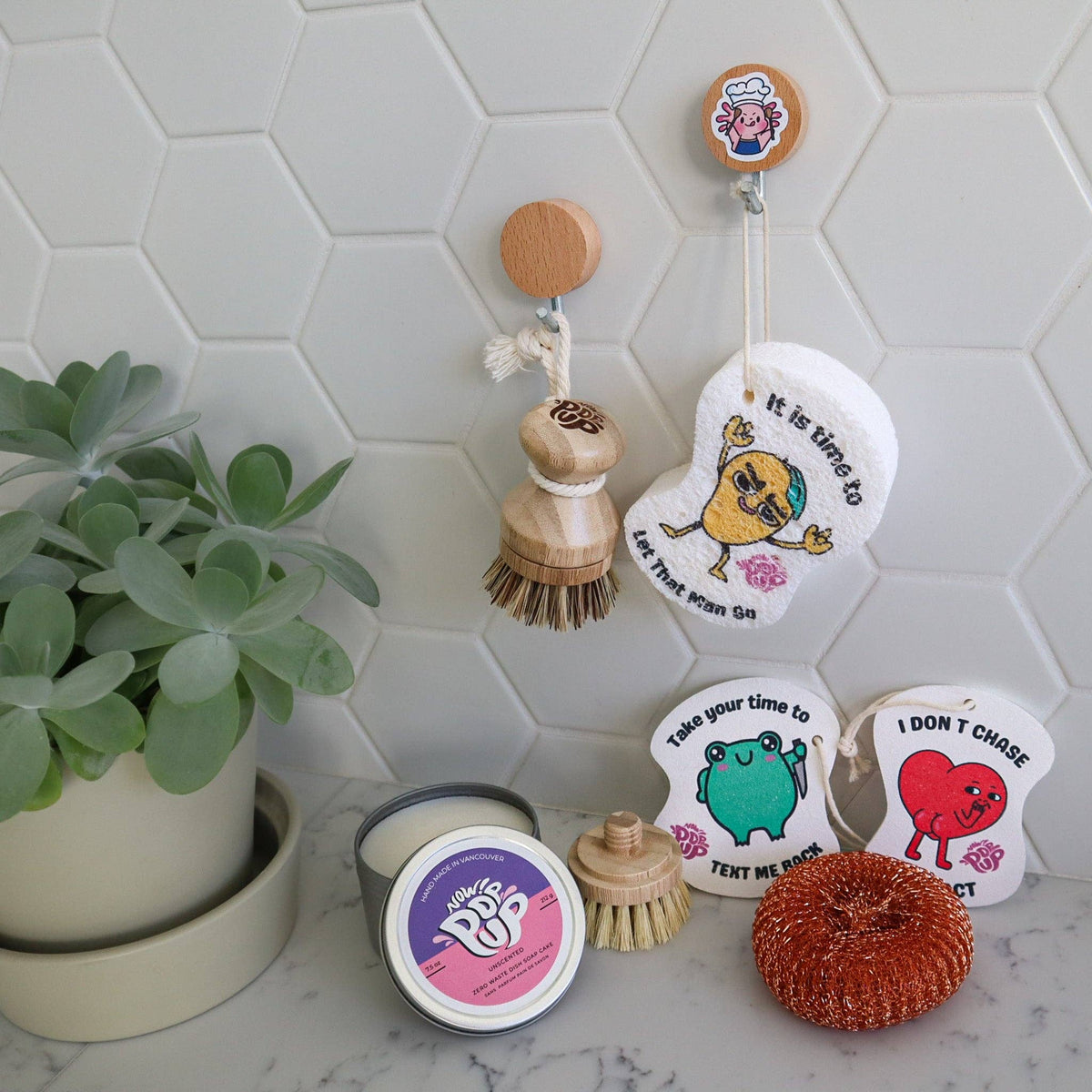 Plantish recycled-copper pop-up dish scrubby, copper pop-up scrubber displayed with natural cleaning supplies