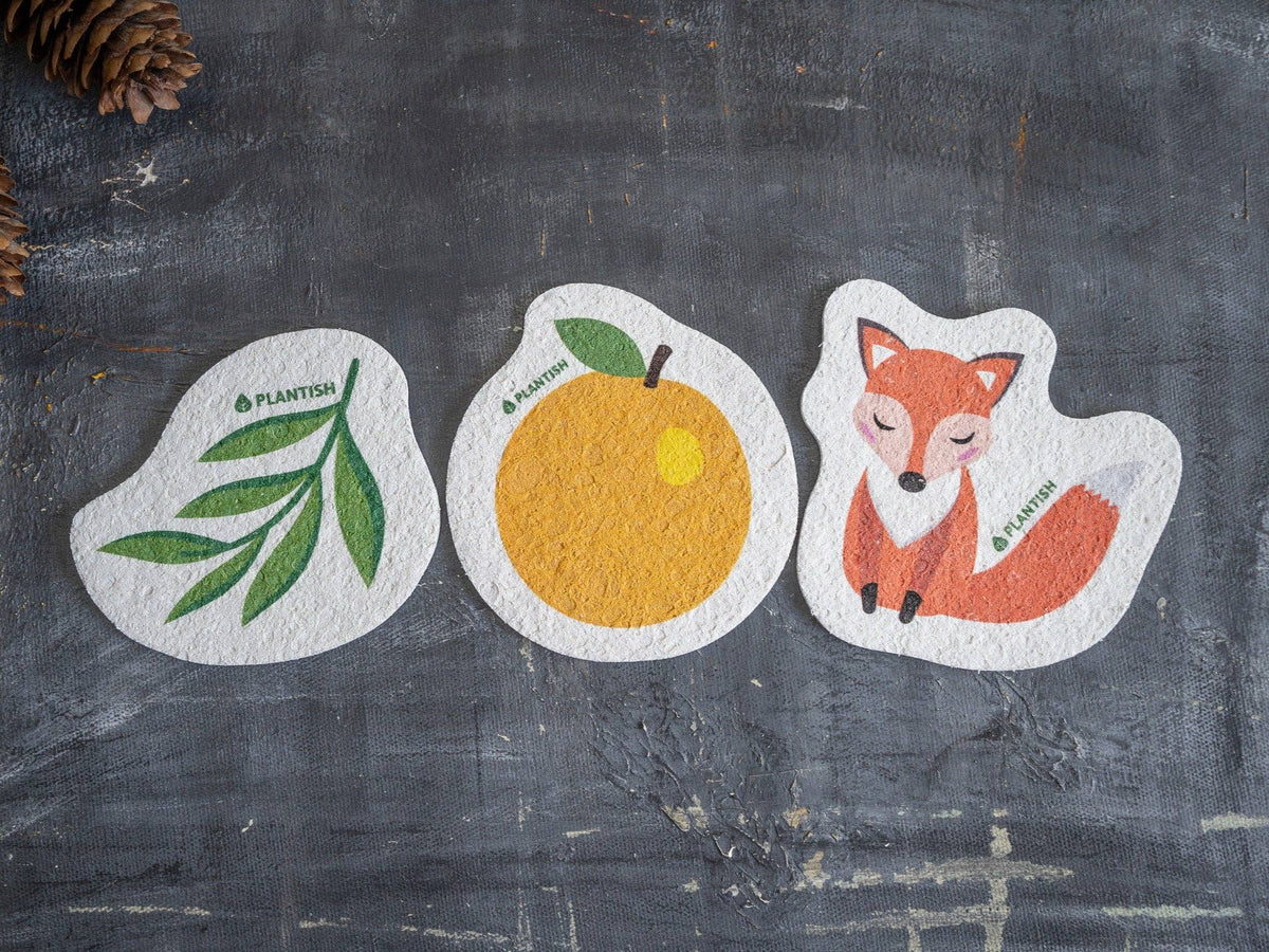 Plantish plastic-free compostable orange cellulose sponge, three plant-based pop-up sponges in orange and leaf designs