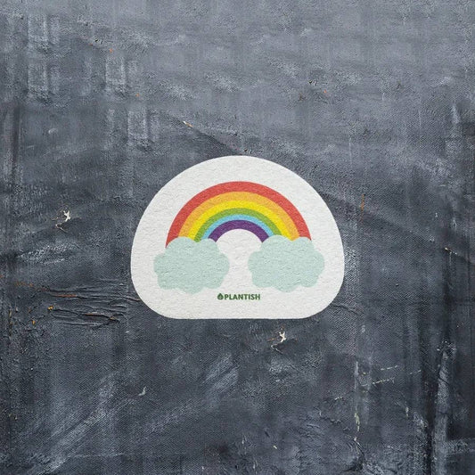 Plantish Rainbow Cloud - Pop-up Sponge - rainbow cloud sponge against dark surface; plant-based