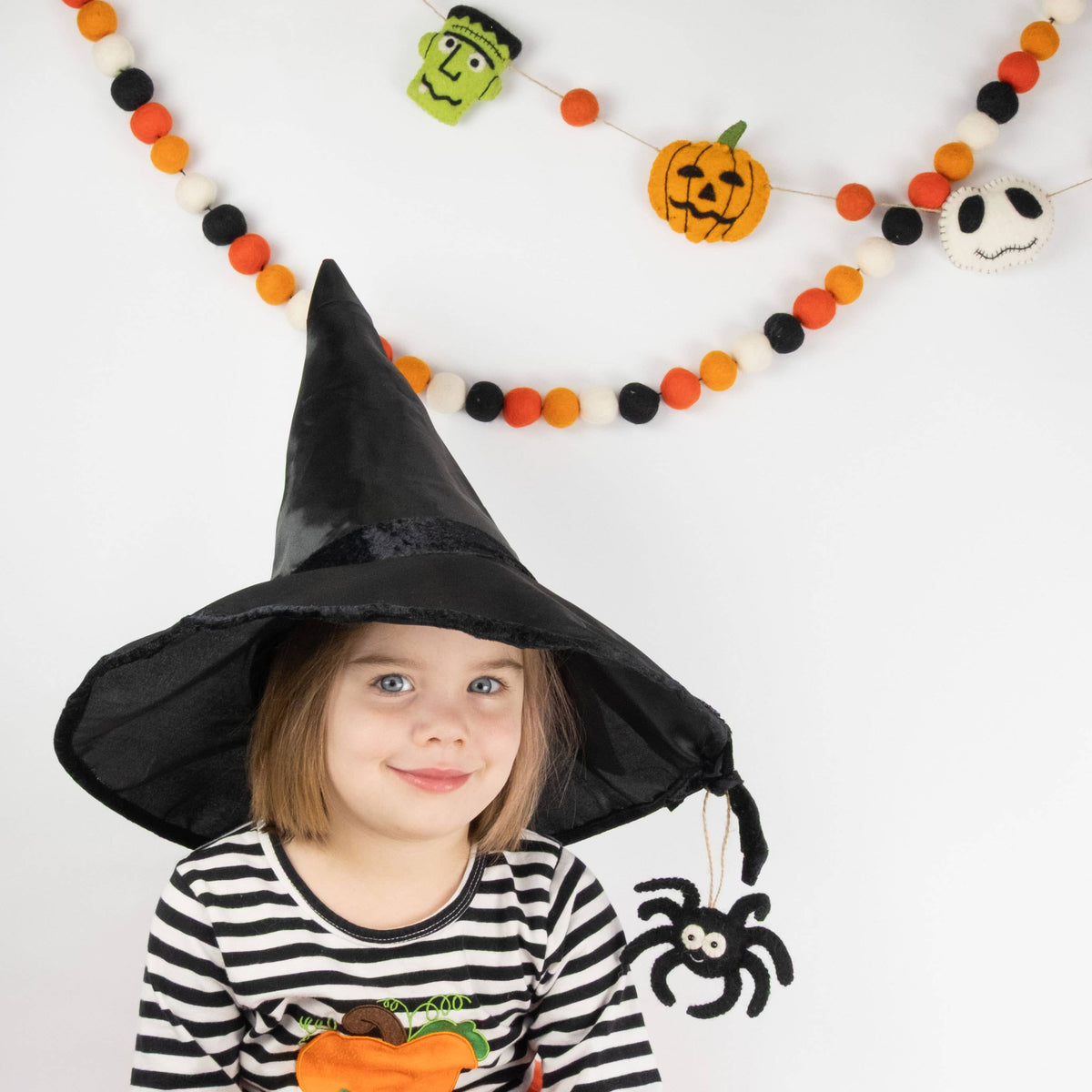 The Winding Road - Ornament - Halloween Decor - Spider — child in witch costume near felt Halloween decorations