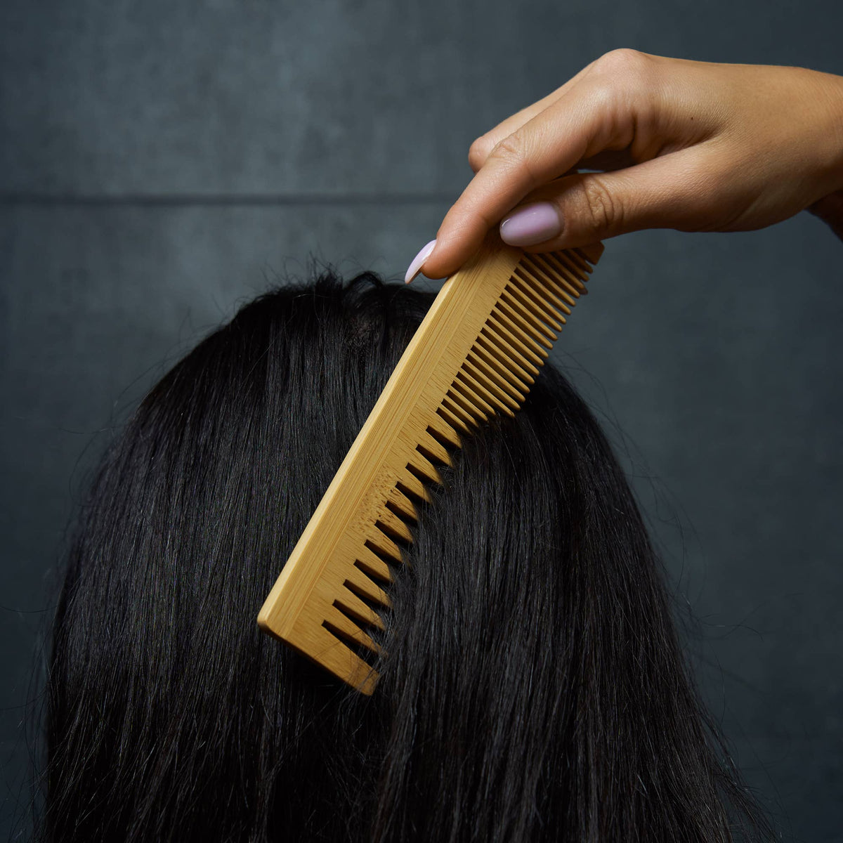 Bamboo Switch Bamboo Dual Comb - woman running bamboo comb through hair