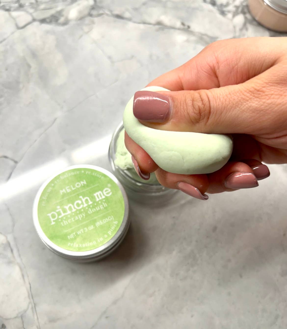 Pinch Me Therapy Dough – Melon, held or used in a calming play setting