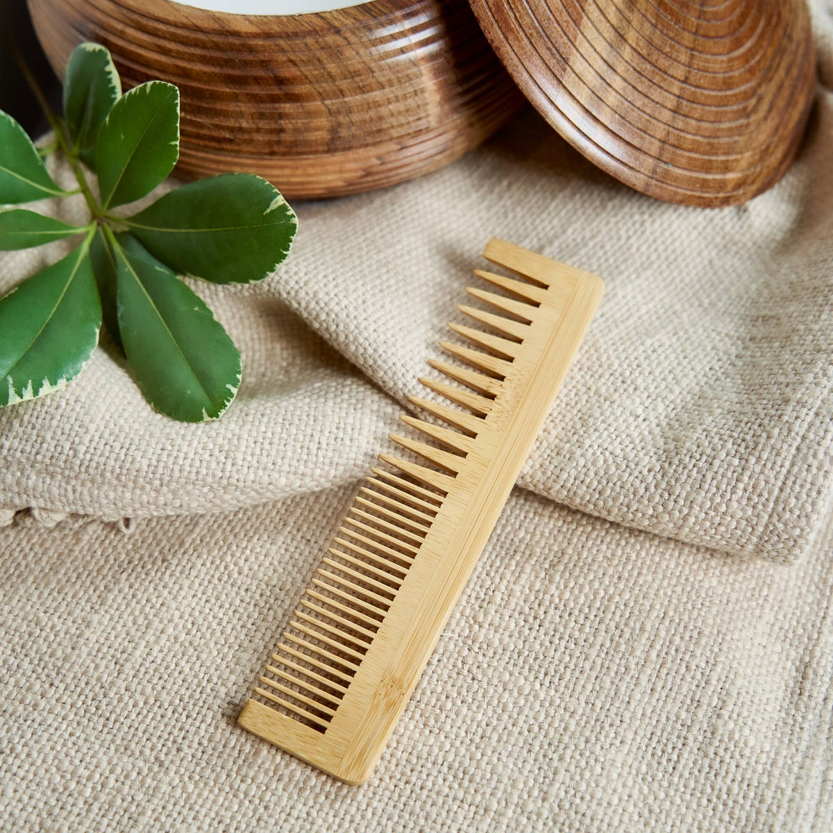 Bamboo Switch Bamboo Dual Comb - bamboo hair comb beside woven baskets