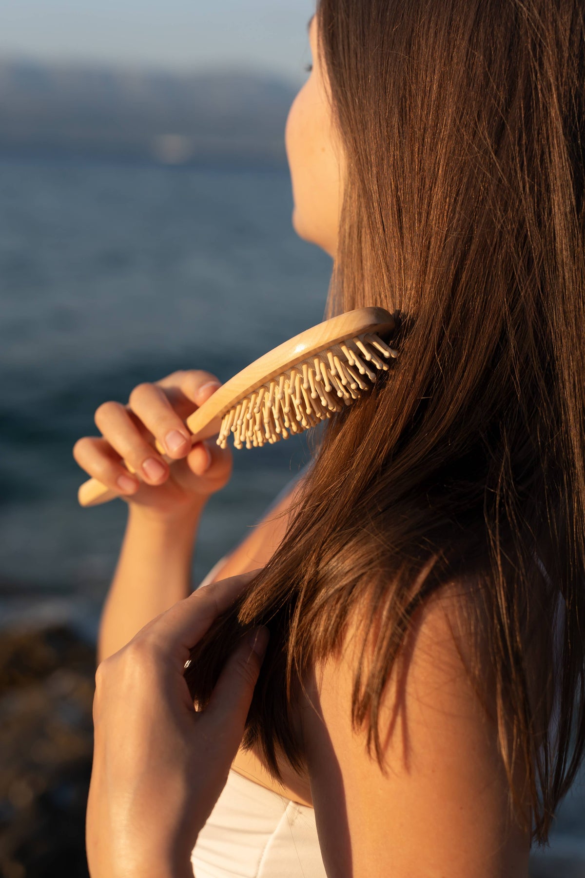 Croll & Denecke vegan birch wood paddle hairbrush, side view of wooden hairbrush in long dark hair