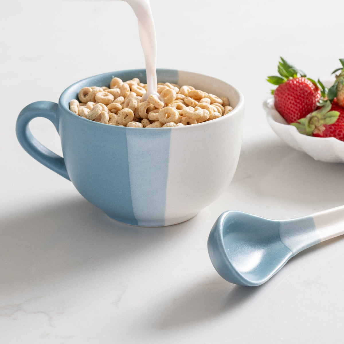 Ten Thousand Villages Pheeka striped jumbo mug filled with breakfast cereal and fruit