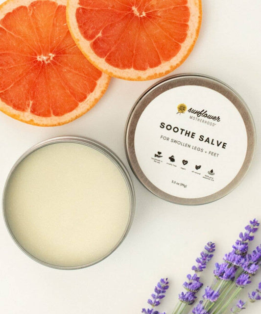 Sunflower Motherhood vegan Soothe Salve for pregnancy leg and foot care, balm tin beside lavender and grapefruit