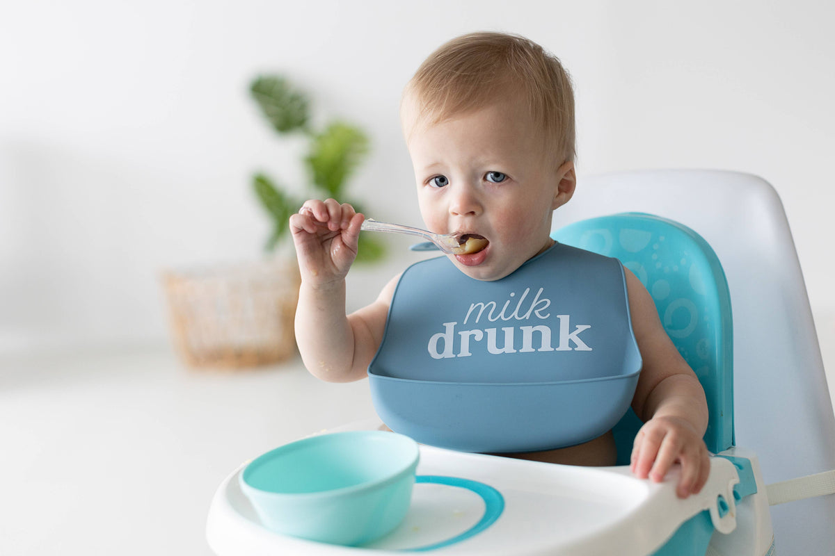 Pearhead Baby Bib Set, Milk Drunk, Silicone, Set of 2: baby clothing displayed flat