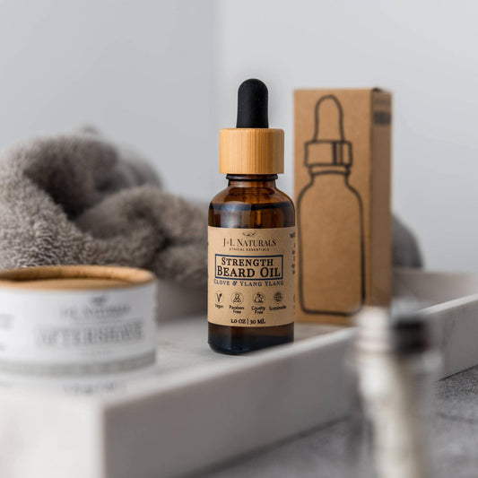 J&L Naturals Natural Beard Oil - 3 regimens - amber dropper bottle on bathroom shelf beside box