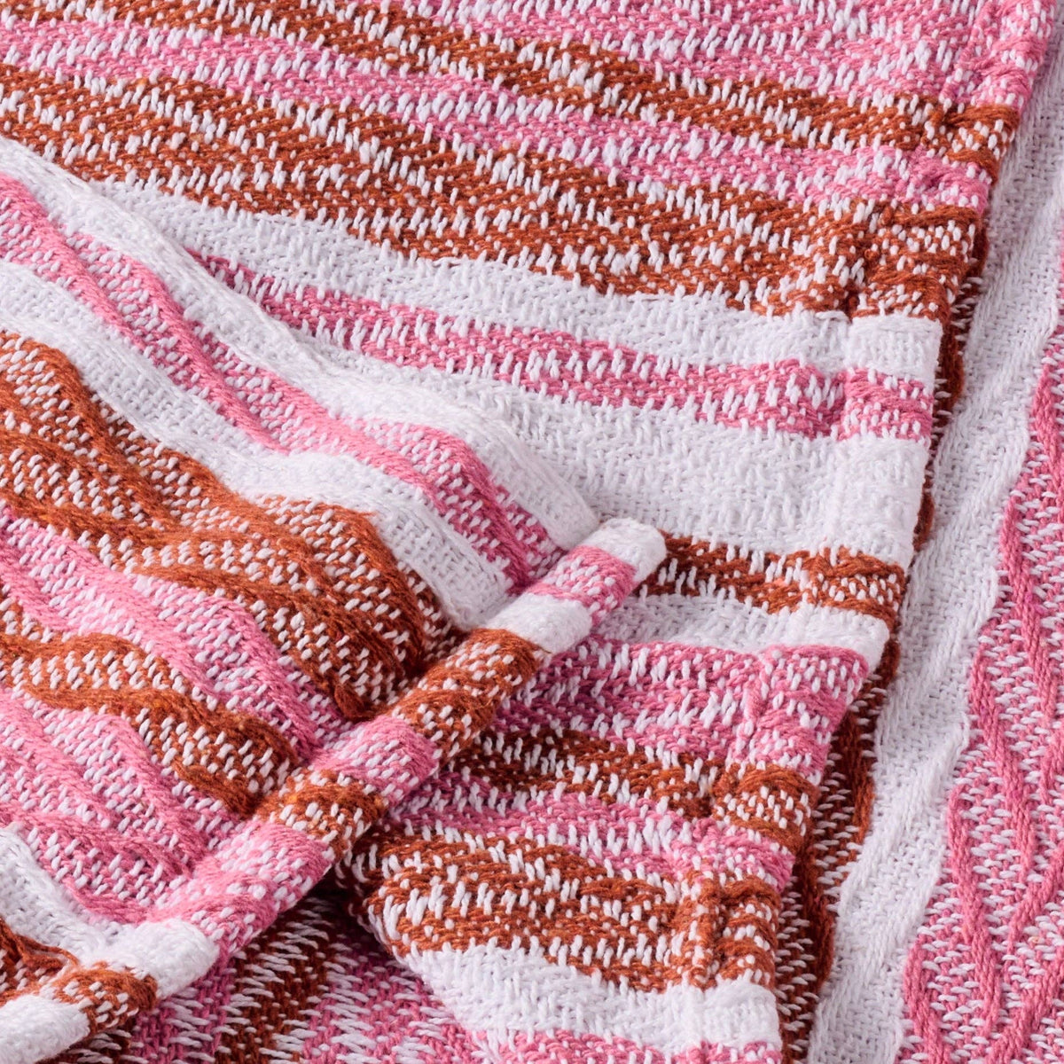 Ten Thousand Villages Garmee Upcycled Cotton Beach Blanket - Pink: blanket staged in living space; recycled cotton fabric