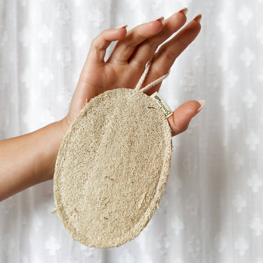 Bamboo Switch Large Oval Exfoliating Loofah - oval loofah exfoliating pad rubbed against hand; compostable natural loofah