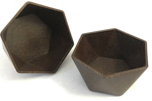 Loopy Products reusable hexagonal snack bowls made with upcycled crop waste, two dark earth-tone hexagonal bowls