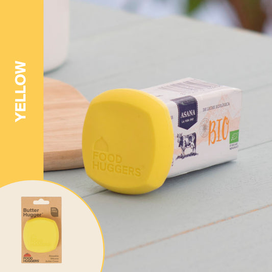 Food Huggers – Reusable Silicone Butter Saver – Yellow, styled in a lifestyle setting; BPA-free silicone