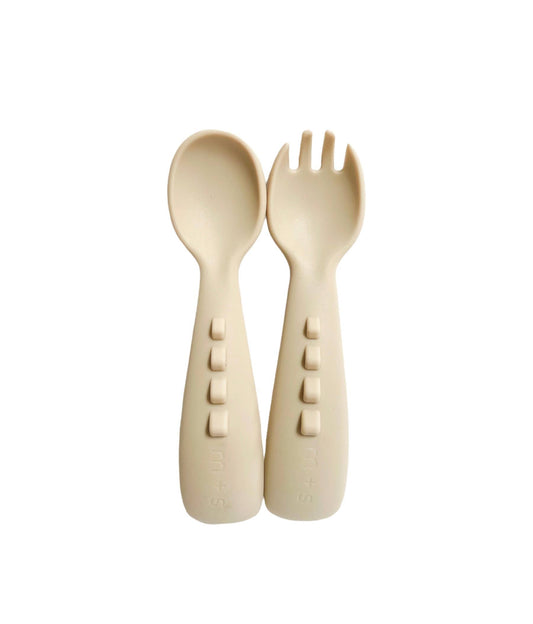 Marlow and Sage food-grade silicone dinosaur toddler utensils, cream child fork and spoon with dinosaur shapes