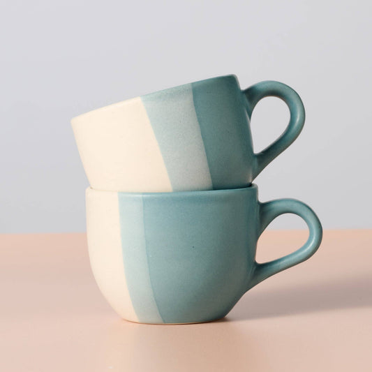 Ten Thousand Villages handcrafted Pheeka ceramic tea cups — two blue and cream striped tea cups stacked