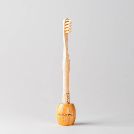 J&L Naturals Wood Toothbrush Stand - wooden stand holding a bamboo toothbrush