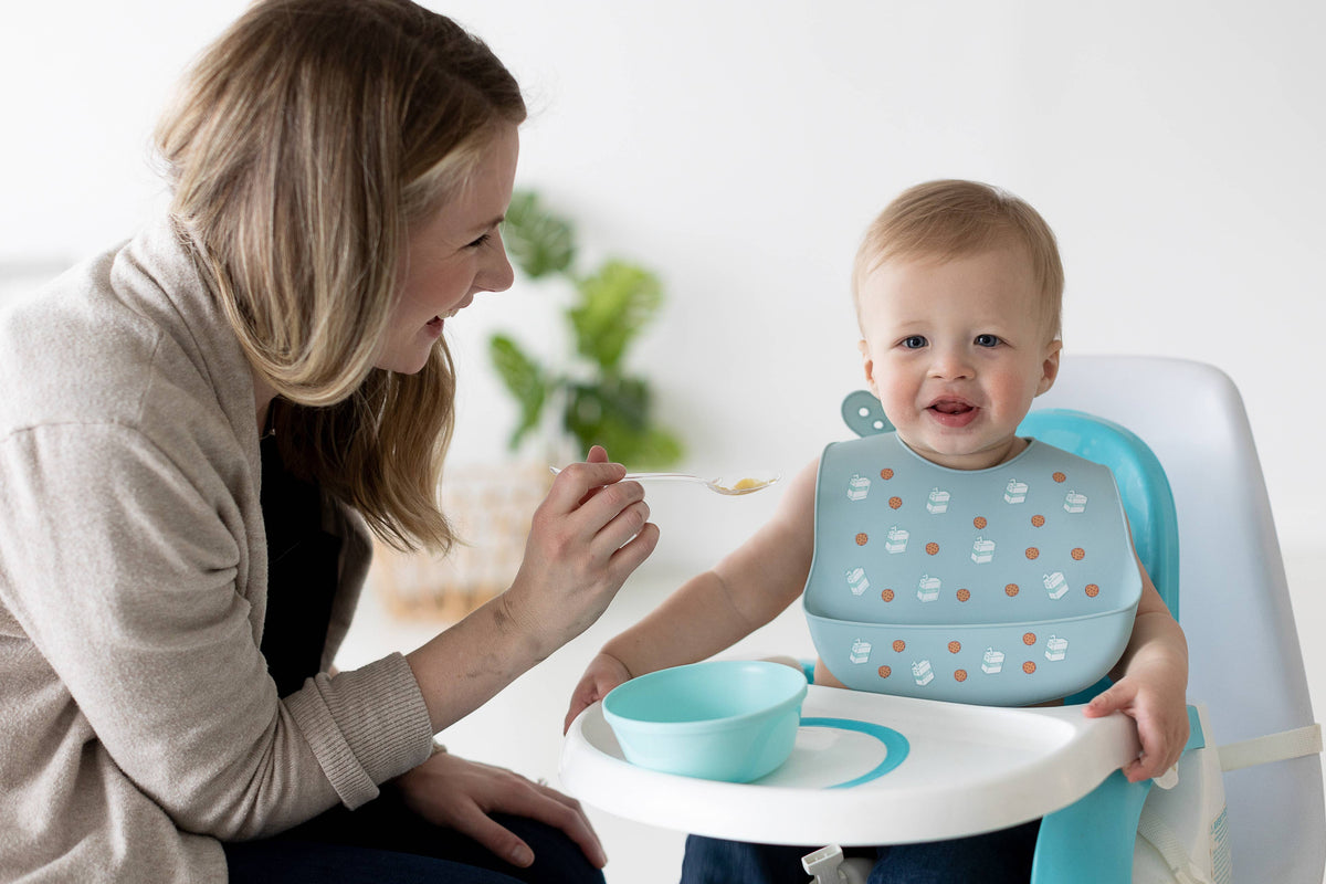 Pearhead Baby Bib Set, Milk Drunk, Silicone, Set of 2: child wearing the outfit