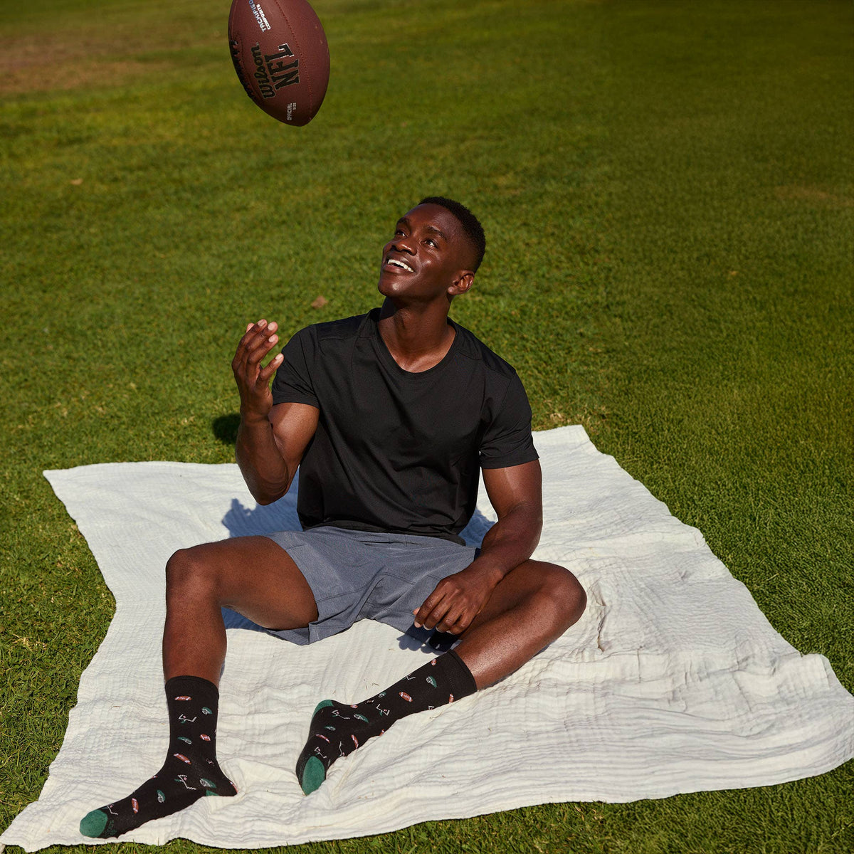 Socks that Support Youth Sports | Black Footballs