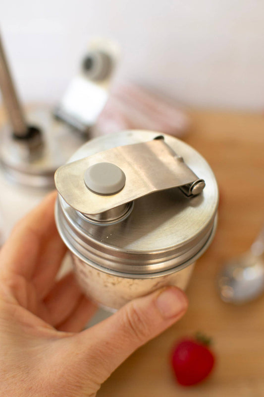 Zefiro Pourable Jar Lid - Wide Mouth - Stainless Steel - stainless steel pourable jar lid held open by hand