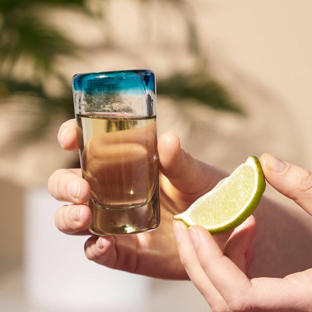 Twine – Primavera Hand Blown Recycled Glass Shot Glasses Set of 4, product held in a hand