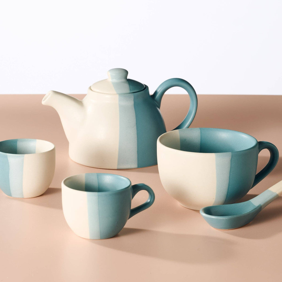 Ten Thousand Villages coordinating striped ceramic mugs, teapot and spoons in blue and cream