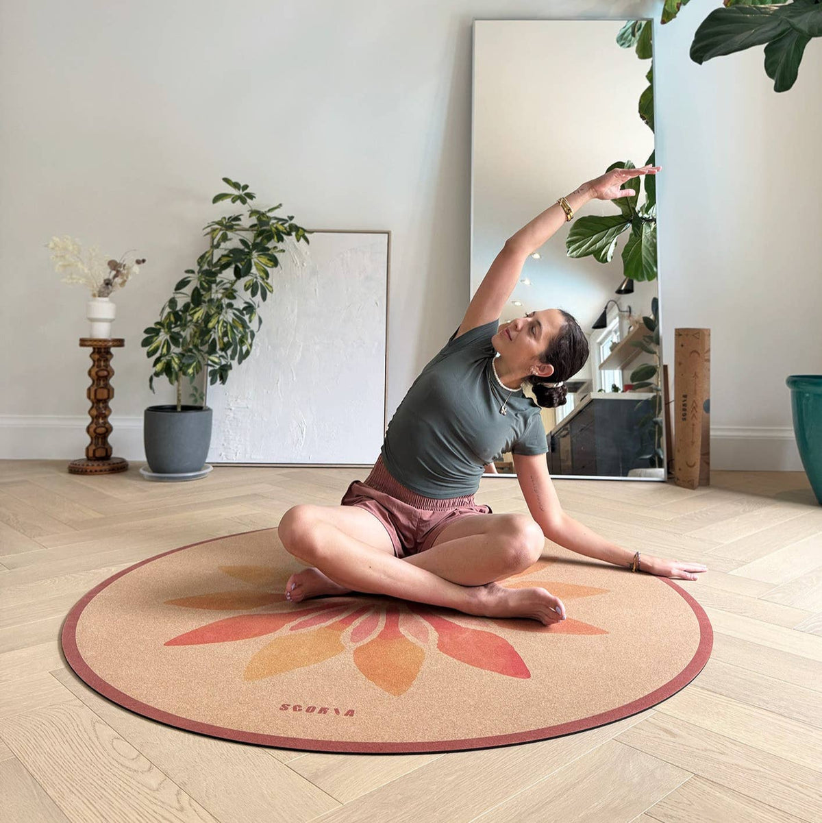 Scoria ® – Solar Bloom Round Cork Yoga Mat | Multi-use | 53", demonstrated in a lifestyle photograph; natural cork material
