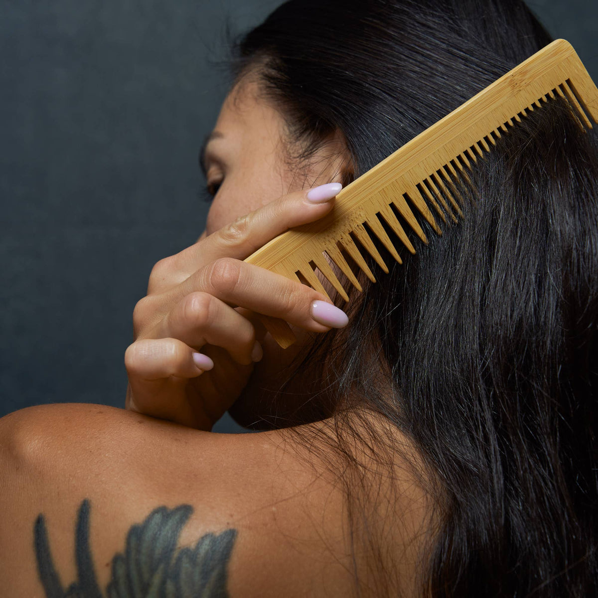 Bamboo Switch Bamboo Dual Comb - woman combing long dark hair