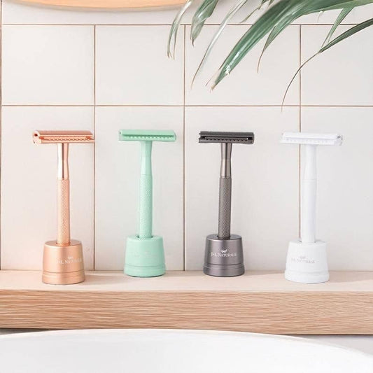 J&L Naturals Reusable Safety Razor Set -Razor, Razor Stand, Refill Blades - four metal razors on wooden bathroom shelf